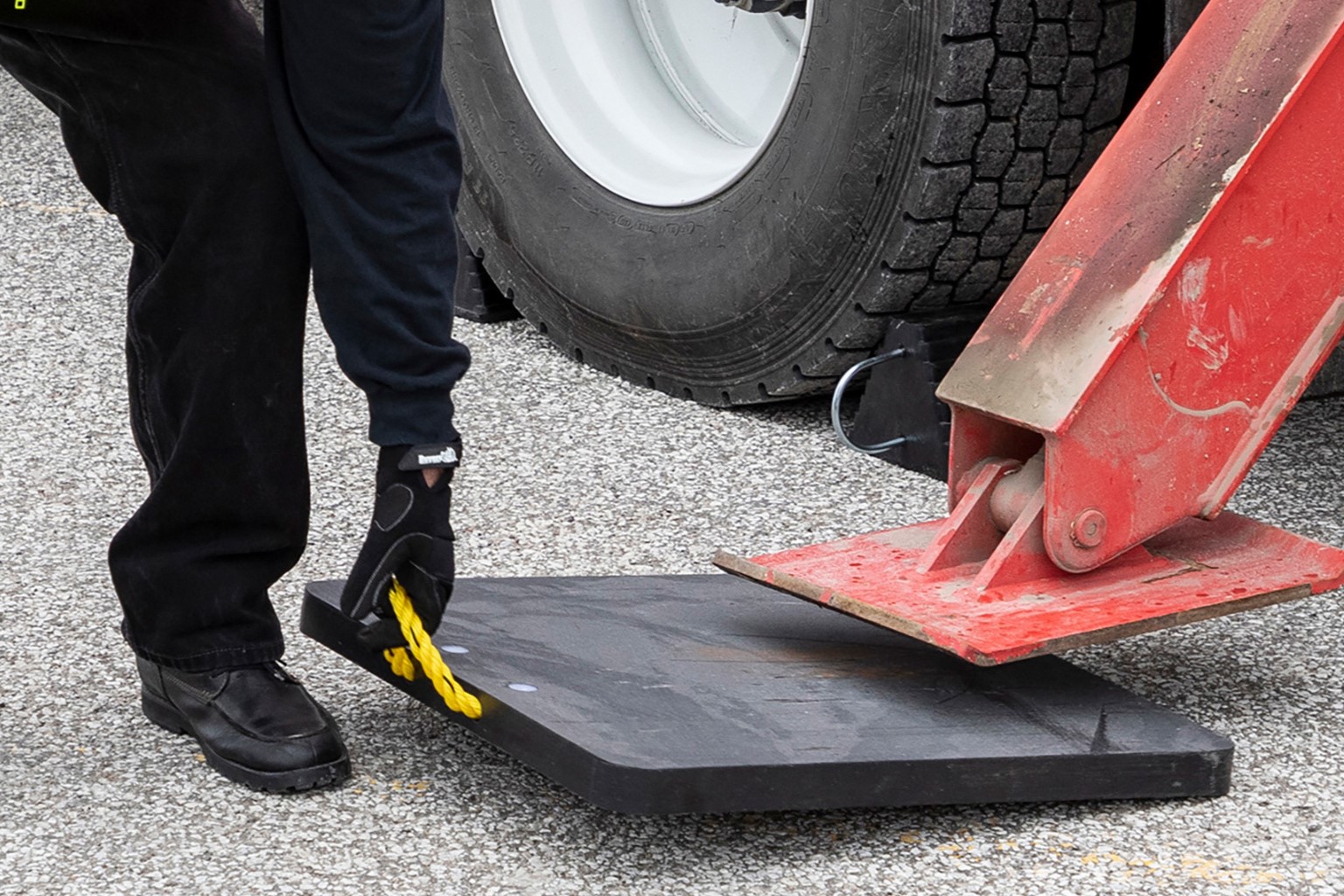 Skid steer on ground protection mats